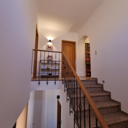 a staircase in a home with white walls at Casa Dos Cedros in Lagos