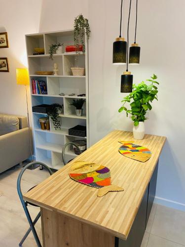 a wooden table with two paintings on it in a room at Countryside studio in Borzęcin Duży