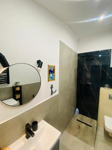 a bathroom with a sink and a mirror at Countryside studio in Borzęcin Duży