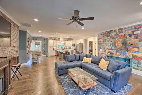 a living room with a blue couch and a kitchen at 2 Mi to Downtown Luxe Greenville Retreat! in Greenville