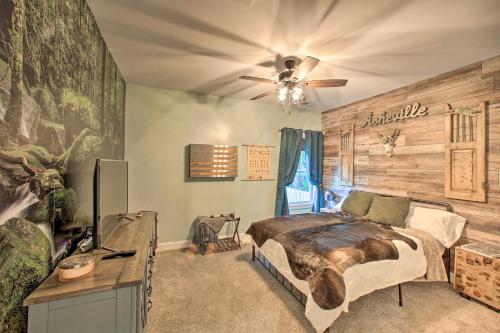 a bedroom with a bed and a wooden wall at 2 Mi to Downtown Luxe Greenville Retreat! in Greenville