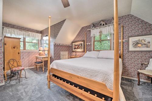 a bedroom with a bed in a room with wallpaper at Bryson City Cabin with Hot Tub about 10 Mi to Dtwn! in Lauada