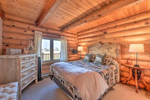 a bedroom with a bed in a log cabin at Stunning Driggs Retreat with Private Hot Tub and Pond! in Driggs