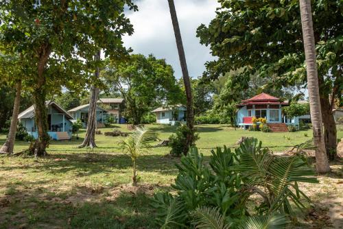 a group of houses in a park with trees at Miss You Beach Resort Koh Mak in Ko Mak