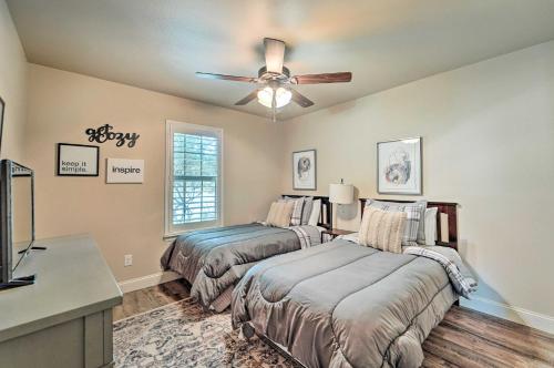 a bedroom with two beds and a ceiling fan at Quaint Lubbock Home about 6 Mi to TTU and Downtown! in Lubbock