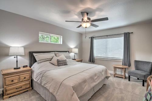 a bedroom with a bed with a ceiling fan and a chair at Gorgeous Loveland Townhome Less Than 1 Mi to Downtown in Loveland