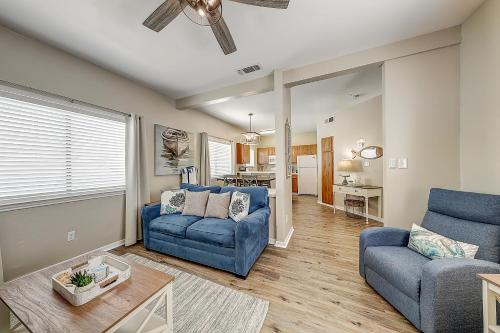 a living room with two blue chairs and a couch at Leeward Isles 207 in Padre Island
