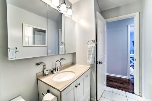 a white bathroom with a sink and a mirror at Pittsburgh Retreat with Deck about 4 Mi to Dtwn! in Pittsburgh