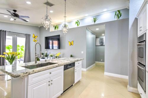 a kitchen with white cabinets and a sink at Sleek Hialeah Home about 20 Mi to Downtown Miami! in Hialeah