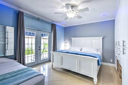 a bedroom with a white bed and a ceiling fan at Sleek Hialeah Home about 20 Mi to Downtown Miami! in Hialeah