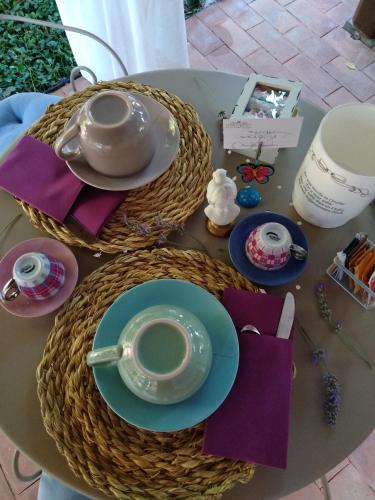 a table with a teapot and a cup of coffee at Petalo Rosso b&b in Lenola