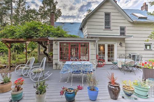 a patio with a table and chairs and potted plants at Charming Historic Retreat Near Poverty Bay! in Federal Way