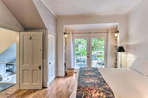 a bedroom with a bed and a door to a patio at Charming Historic Retreat Near Poverty Bay! in Federal Way
