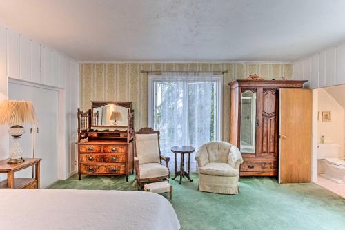 a bedroom with a bed and a table and chairs at Charming Historic Retreat Near Poverty Bay! in Federal Way