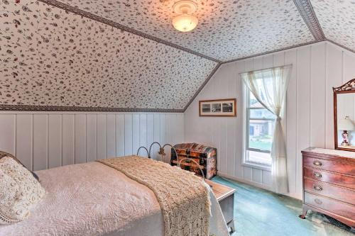 a bedroom with a bed and a dresser and a window at Charming Historic Retreat Near Poverty Bay! in Federal Way