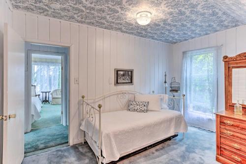 a bedroom with a bed and a dresser and a window at Charming Historic Retreat Near Poverty Bay! in Federal Way
