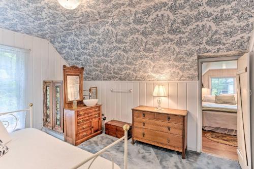 a bedroom with a bed and a dresser and a mirror at Charming Historic Retreat Near Poverty Bay! in Federal Way