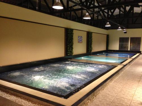 two indoor swimming pools in a building with two lanes at Siam Paradise Entertainment Complex in Bangkok