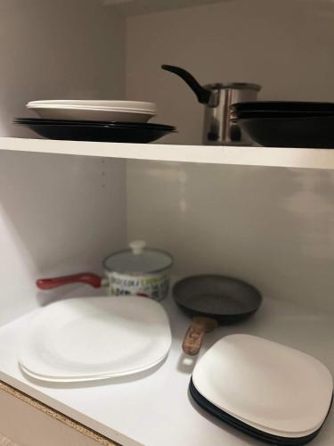 a kitchen counter with two white plates and a sink at Pro arte in Kladovo