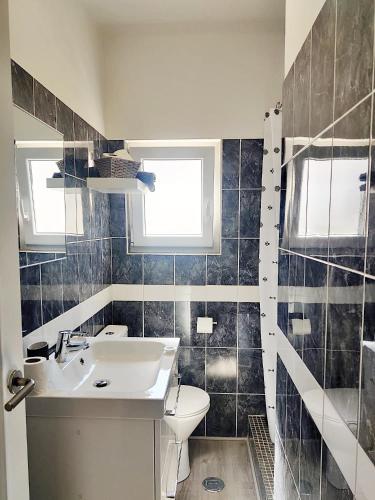 a bathroom with a sink and a toilet at Caroline's in Vila do Bispo