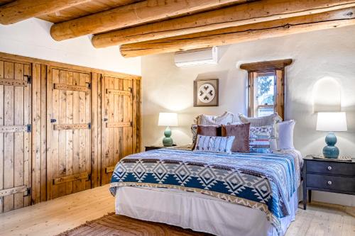 een slaapkamer met een bed, houten wanden en houten vloeren bij Home on the Range in Santa Fe
