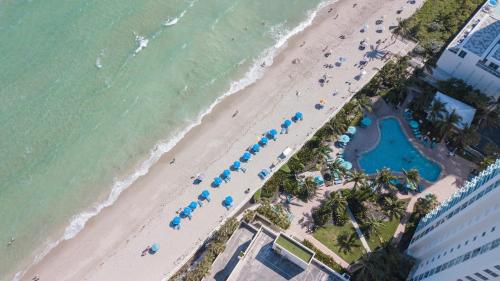 ハリウッドにある2 BEDROOMS 2 FULL BATHROOMS APT. ON THE BEACHの海のパラソル付き海岸の景色