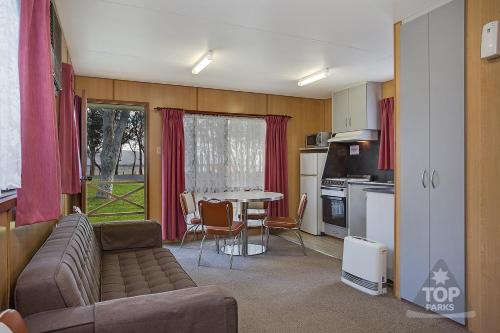 a living room with a couch and a table at Lake Fyans Holiday Park in Lake Fyans