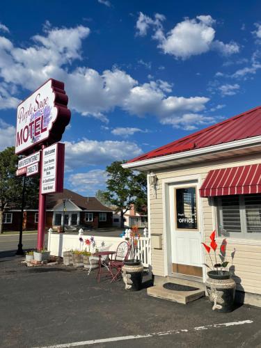a sign for a motel next to a building at Purple Sage Motel in Panguitch