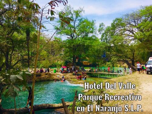 a group of people in a river in a park at Hotel Del Valle in El Naranjo
