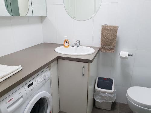 een badkamer met een wasmachine en een wastafel bij Studio 4 - ground floor Fremantle apartment in Fremantle