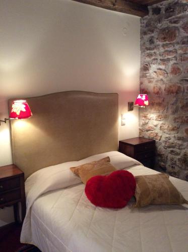 a bedroom with a bed with a red heart on it at Oihalia Guesthouse in Fidhákia