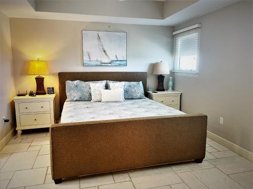 a bedroom with a large bed with two night stands at Sterling Breeze 1007 in Panama City Beach