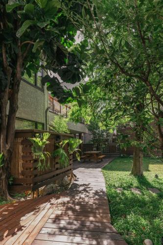 a walkway in front of a building with trees at 檜木居民宿 - 立案證號 一六三 - 一六八 - 一七零 in Jian