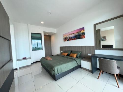a bedroom with a bed and a desk and a mirror at Private Condo Port Dickson Waterfront in Port Dickson