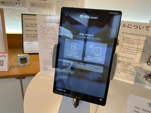 a tablet computer is hanging on a wall at Stay Airport in Fukuoka