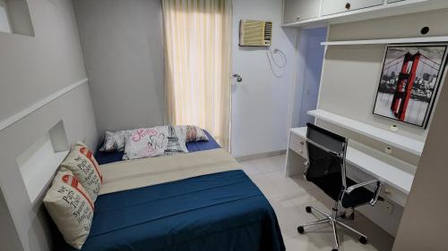 a small bedroom with a bed and a desk at Nader Home's - 3 quartos Laranjeiras in Rio de Janeiro