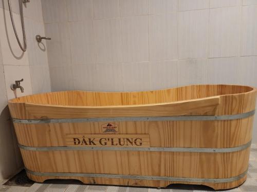 a wooden tub in a bathroom with a shower at Đắk G'lung Bungalow in Bu Yal (1)