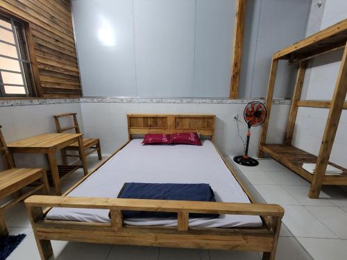 a room with a bed and two benches in it at Đắk G'lung Bungalow in Bu Yal (1)