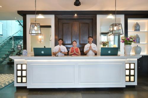 a group of people standing behind a counter at BYD Lofts - Boutique Hotel & Serviced Apartments - Patong Beach, Phuket in Patong Beach
