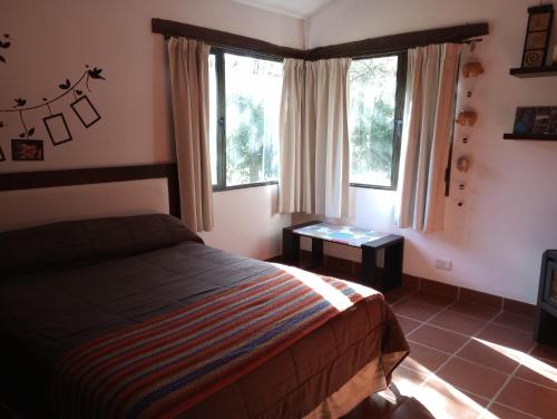 Giường trong phòng chung tại Casa Del Valle Traslasierra