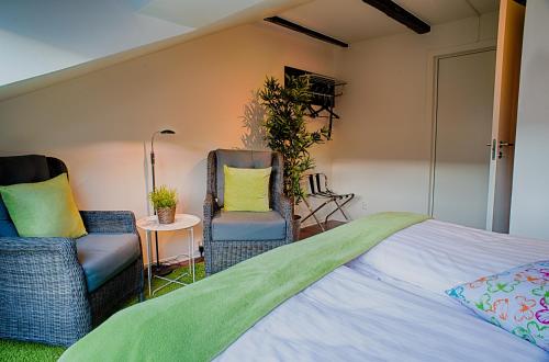 a bedroom with two chairs and a bed at H5 Hotel in Helsingborg