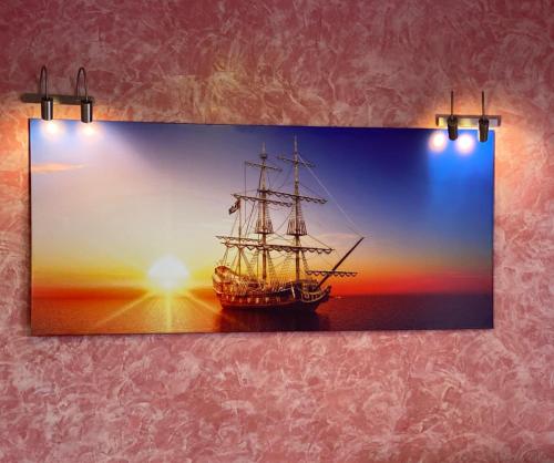 a painting of a ship in the sunset at Orsetto in Sevan