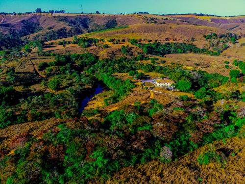 an aerial view of a valley with a house on a hill at Pousada Casarão na Serra in Vargem Bonita