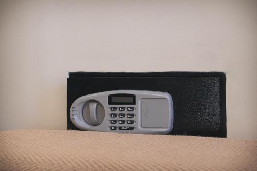 un teléfono en una caja negra sentado en una cama en KT Villa en Troulos