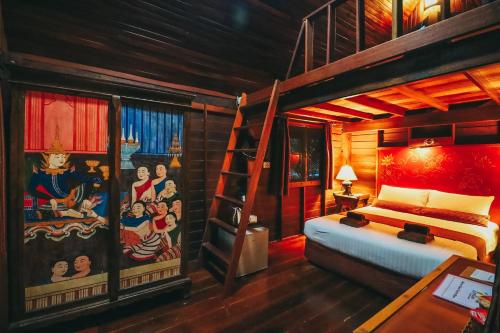 a bedroom with a bunk bed and a ladder at Leeloo Paradise in Khanom