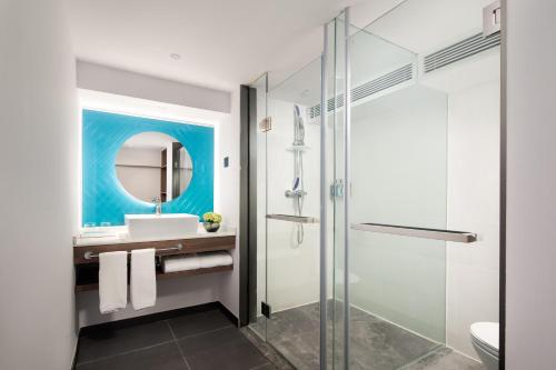 a bathroom with a glass shower and a sink at Holiday Inn Express Chongli, an IHG Hotel in Zhangjiakou