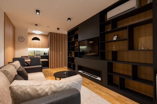 a living room with a couch and a fireplace at President Apartman Spa in Vračar (historical)