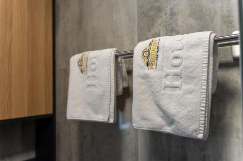 two towels hanging on a towel rack in a bathroom at President Apartman Spa in Vračar (historical)