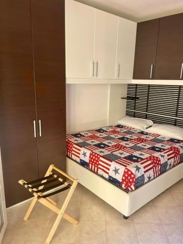 a small bedroom with a bed and a chair at STOP&GO STATION BOLOGNA HOUSE Self Check-In 24-24 Central City-Fiera in Bologna