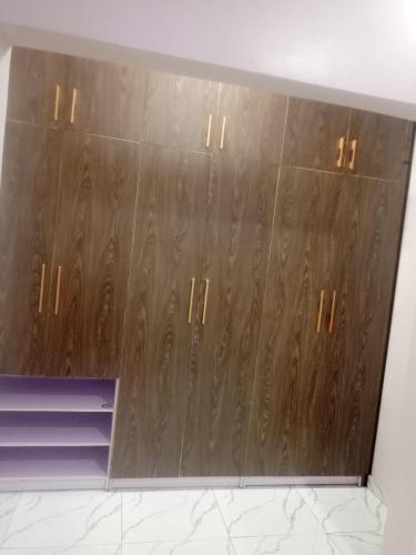 a closet with wooden doors in a room at Captivating 1-Bed Studio in Sapele in Sapele